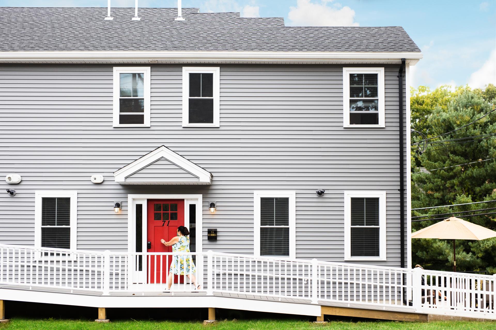 Image of gray house with red door