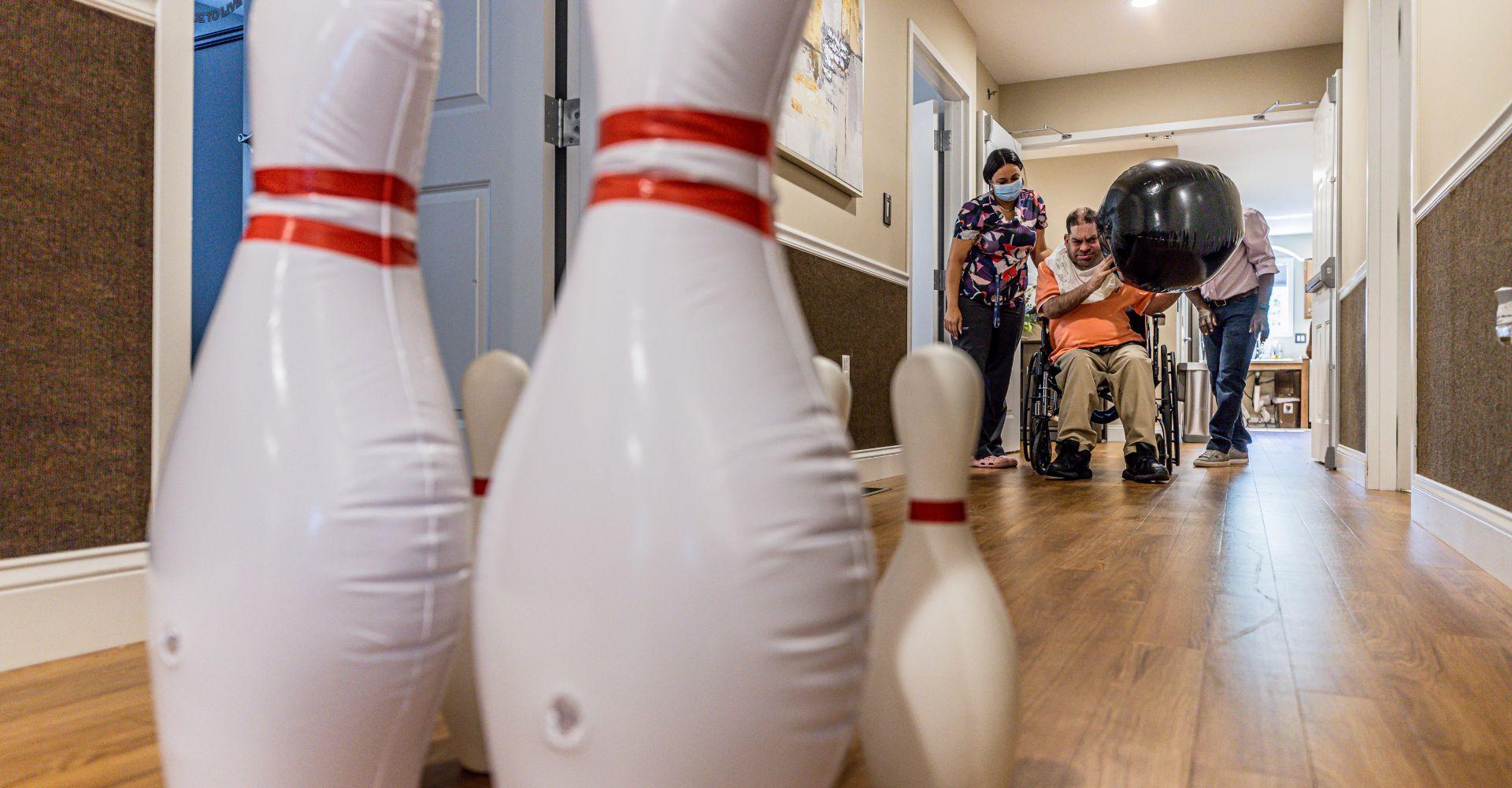 Image of man in wheel chair bowling