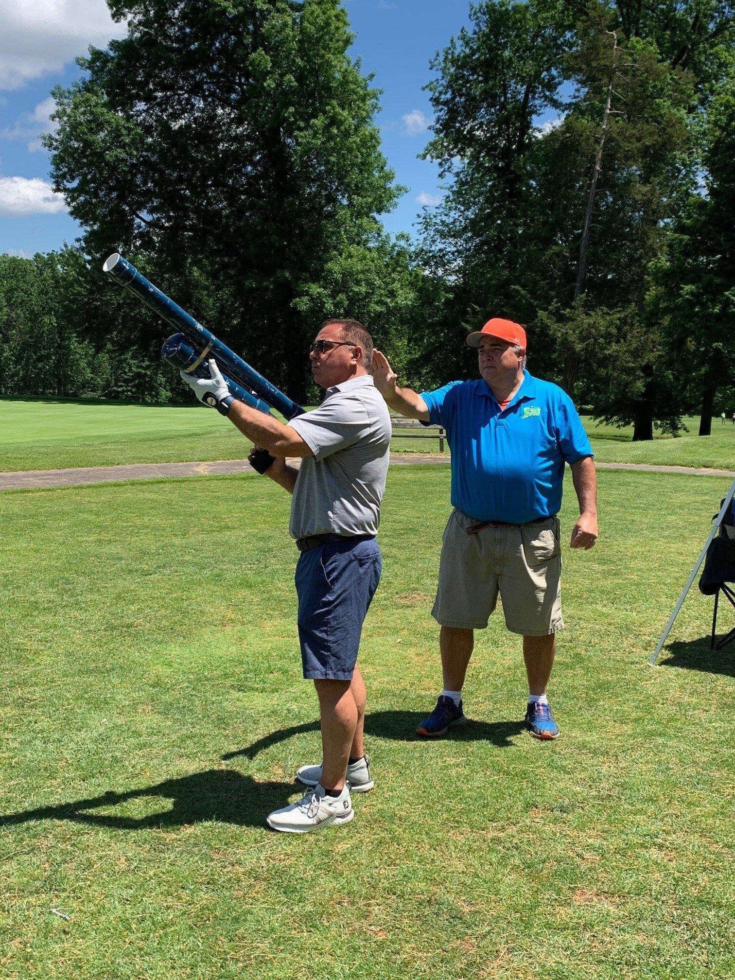 Man shooting hand-held cannon