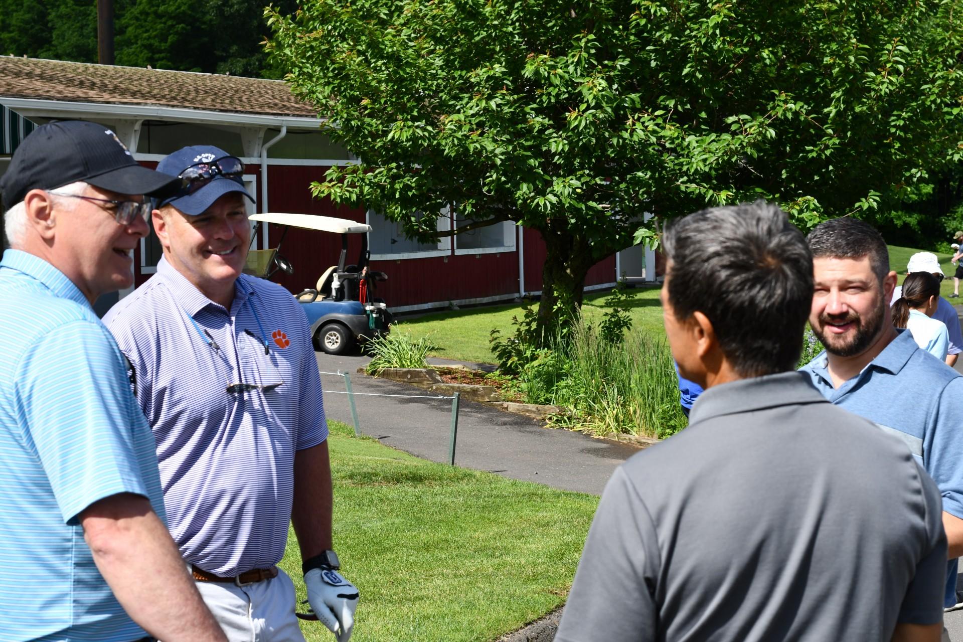 Group of men talking on the course