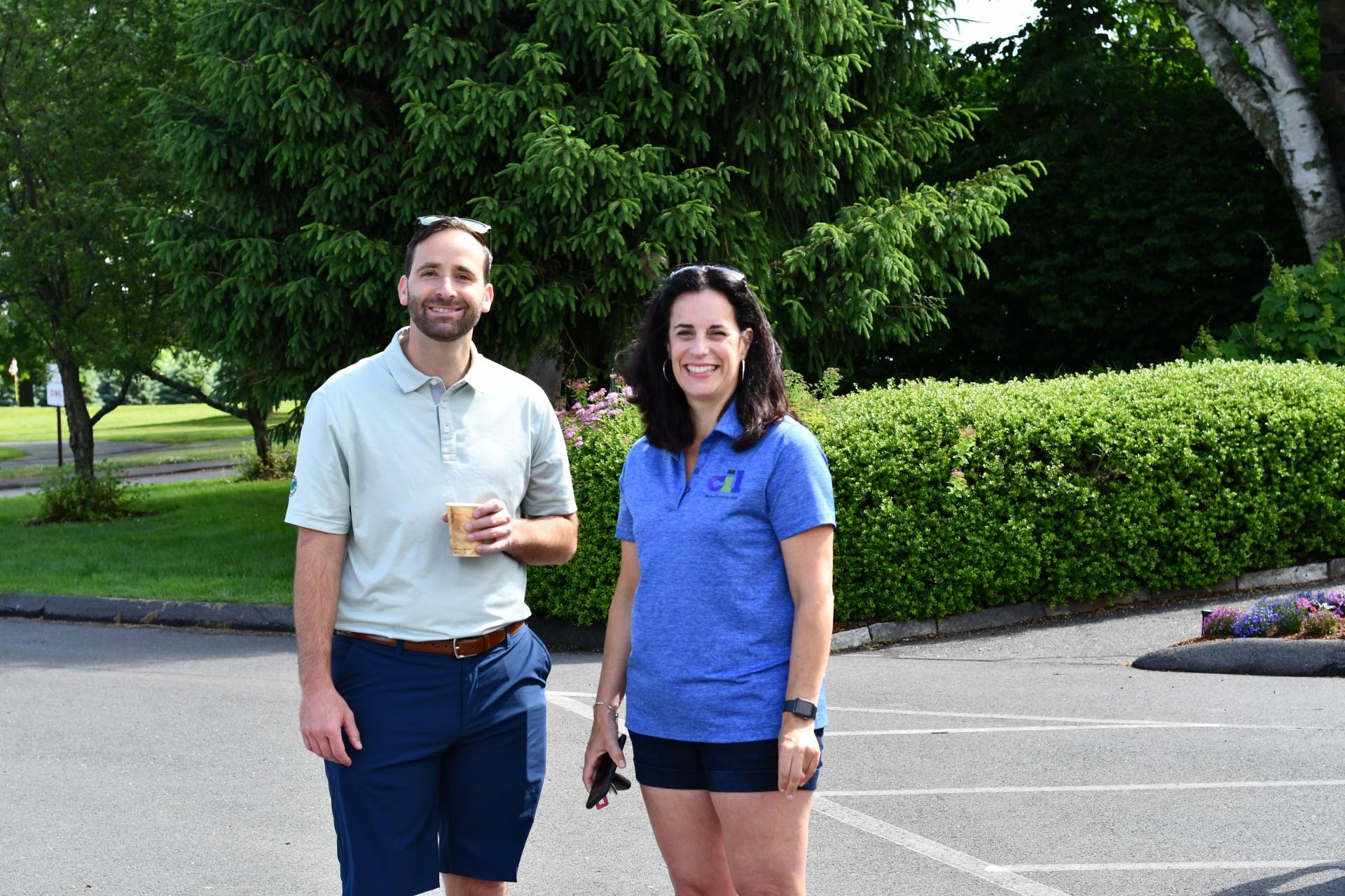 Two individuals posing in the tournament parking lot