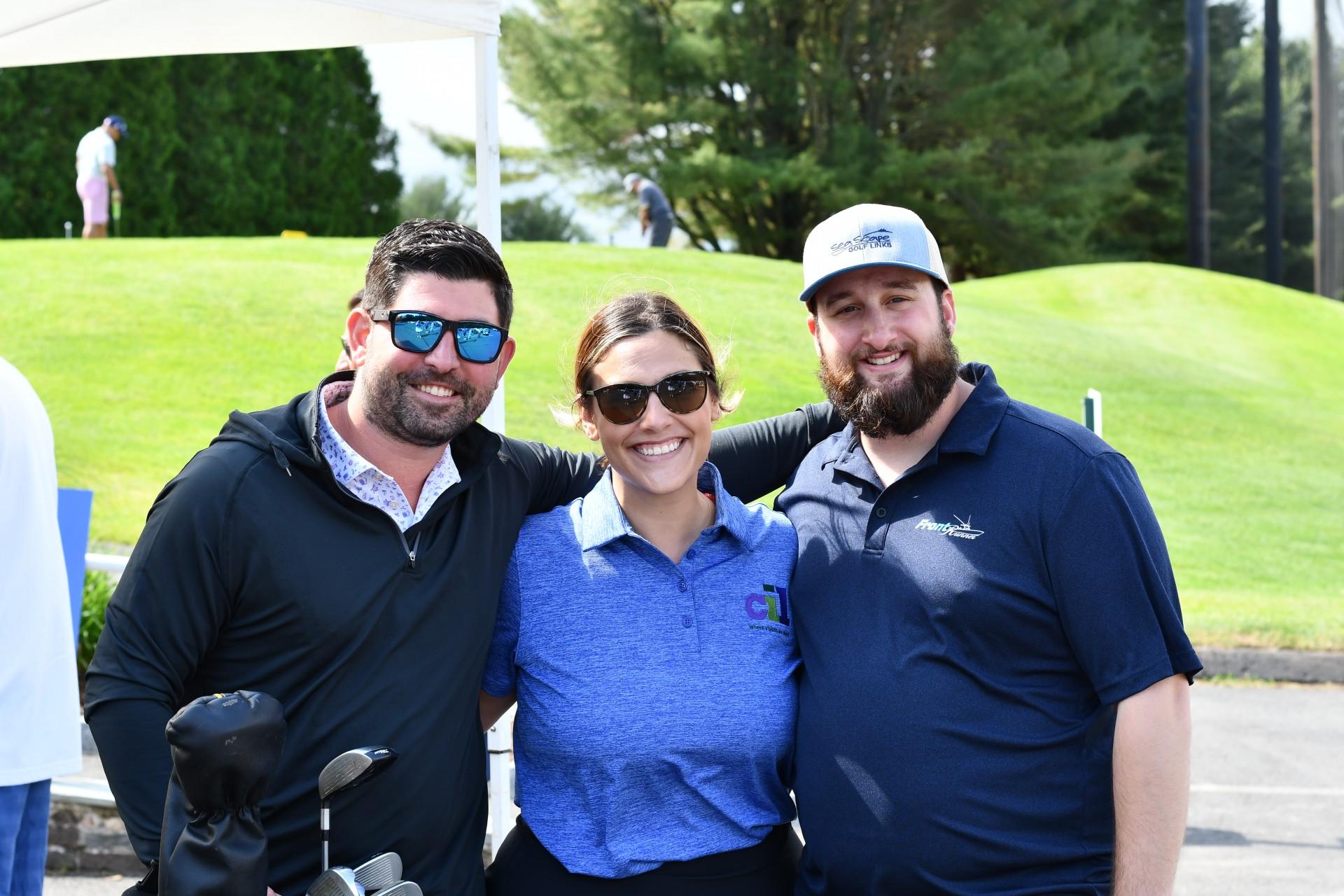 Three CIL golfers smiling for the camera