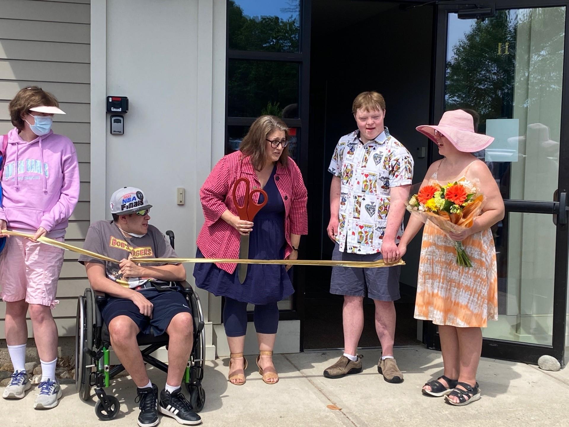 Northampton Mayor Gina Louise Sciarra cutting the ribbon surrounded by three program participants