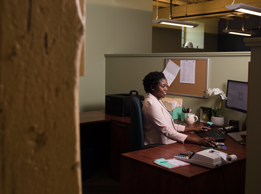 Nataki sitting at her desk