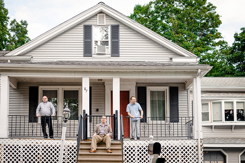 Twin home with three men on the porch