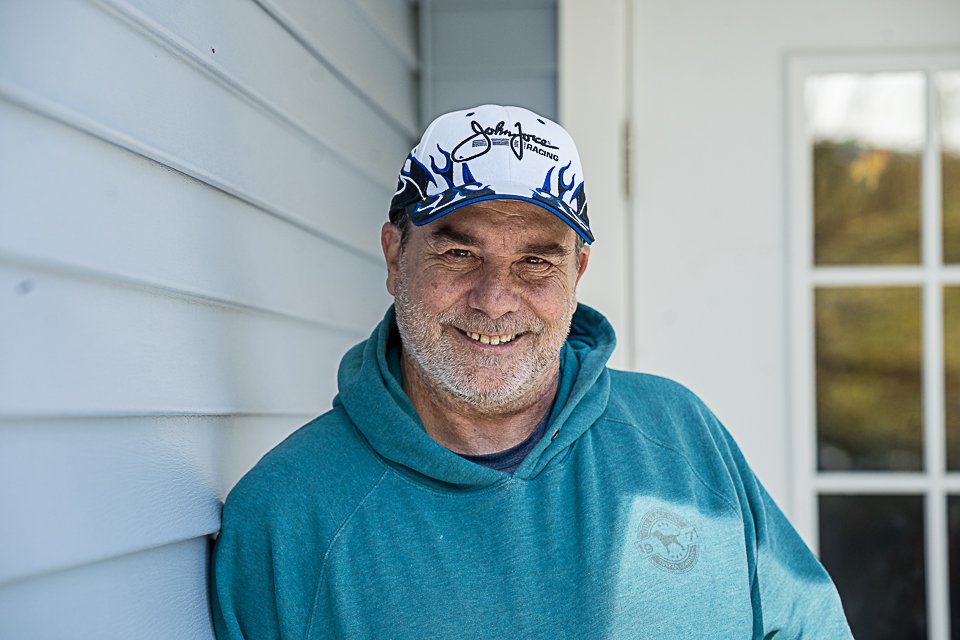 photo of rob smiling outside of his home