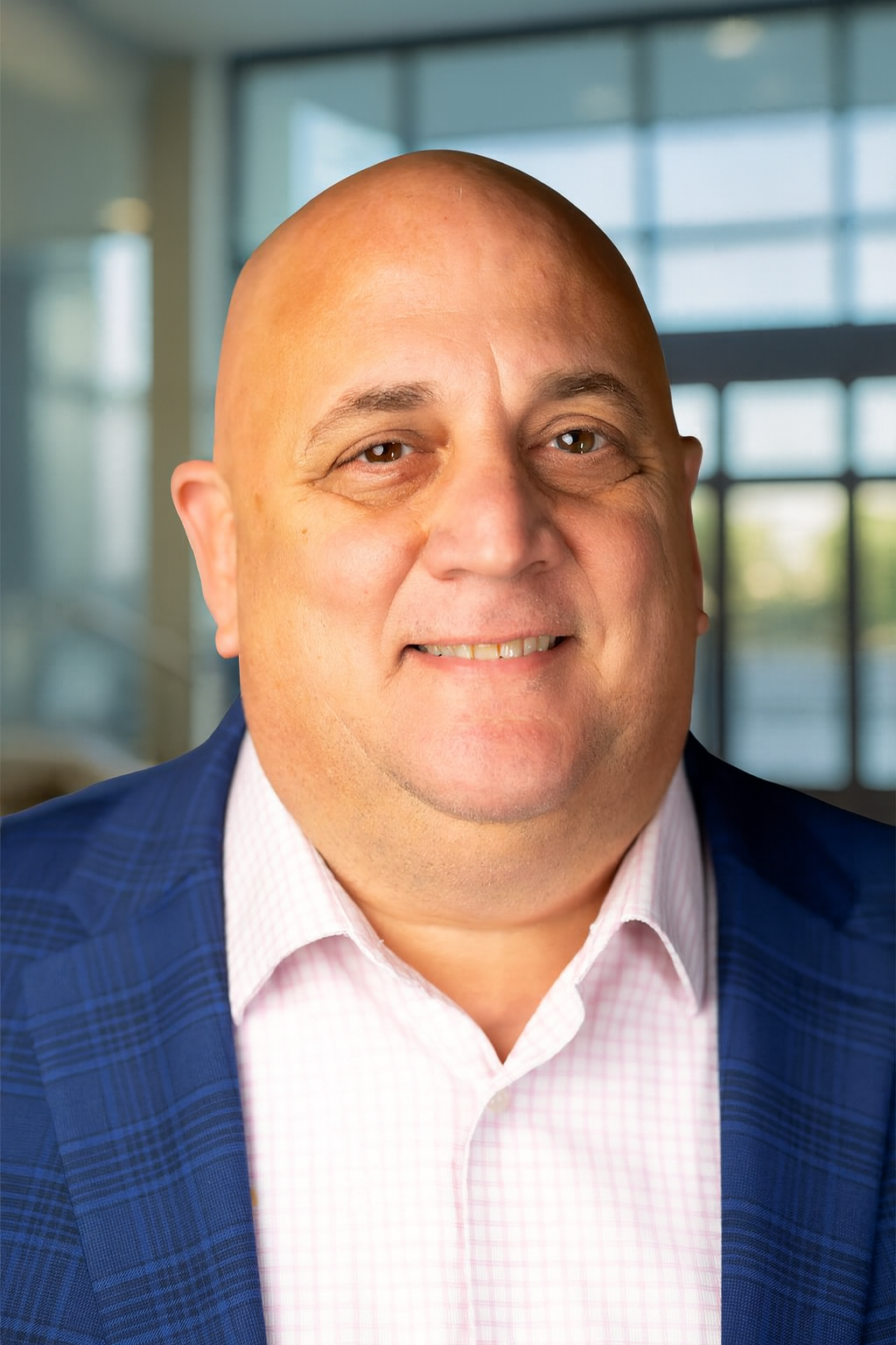 Jim smiling in a professional outfit for his headshot